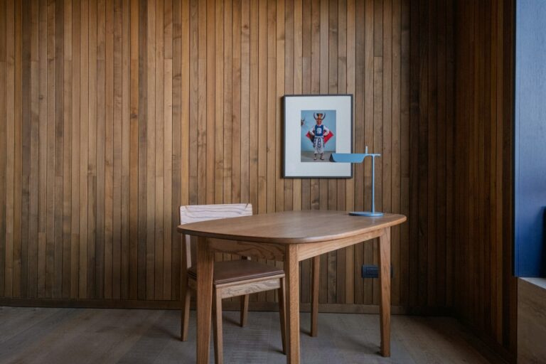 Solid wood table in a room with wood clad walls, inspiration for custom tables