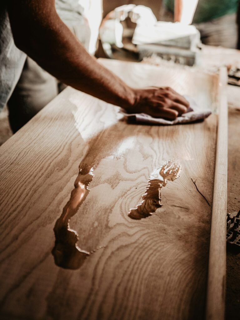 Solid wood tabletop being treated with oil, inspiration for custom tables