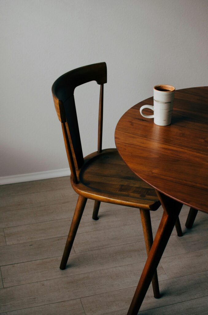 Round dining table in dark solid wood, inspiration for custom tables