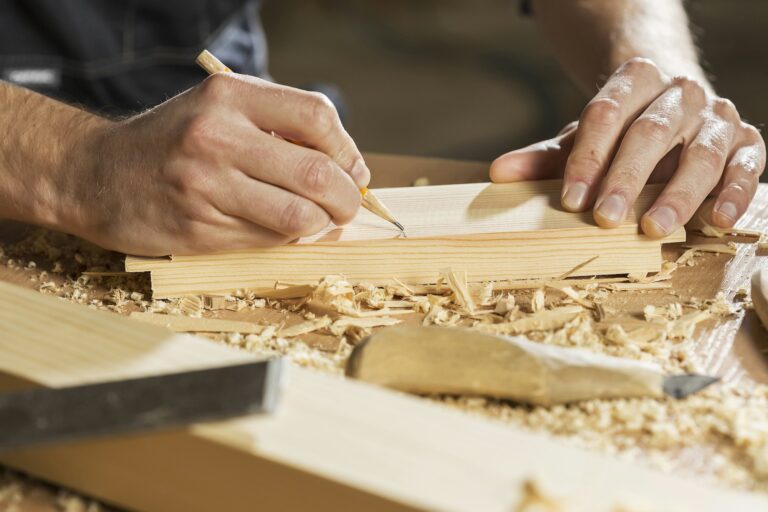 Joiner marking out a wooden tabletop blank, inspiration for custom tables