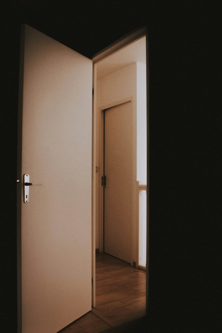 Open modern interior door with light from the hallway, inspiration for custom doors