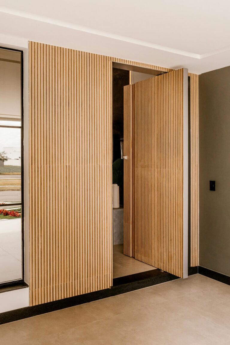 Solid wood pivot door with vertical slats, inspiration for custom doors