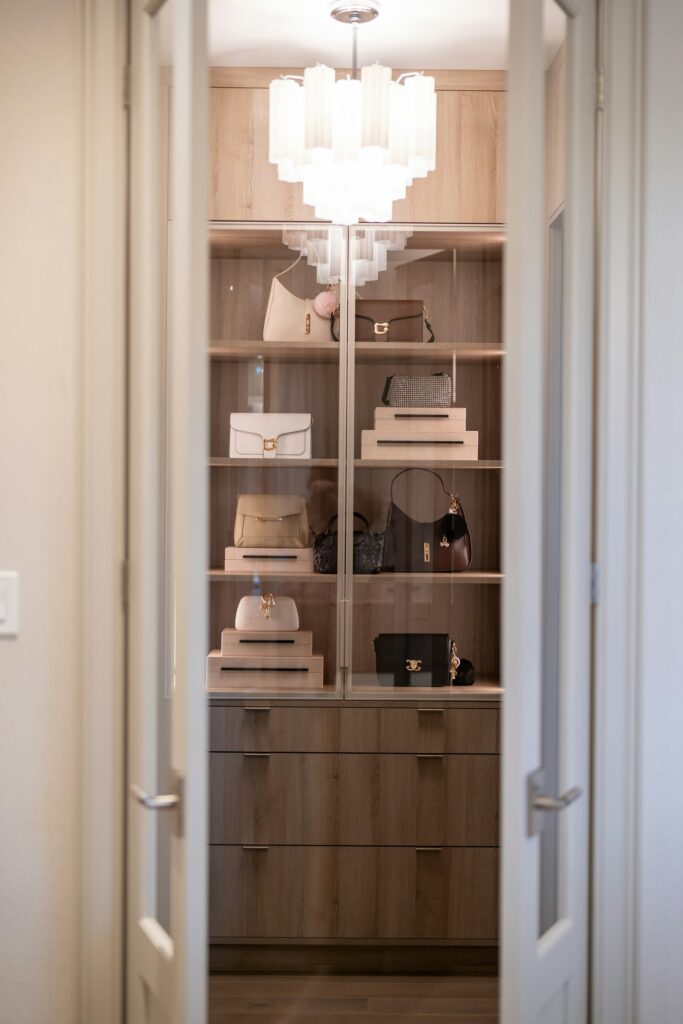 Wardrobe interior with open bag shelves and wooden drawers, inspiration for custom wardrobes