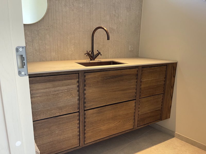 Wall hung vanity unit in smoked oak with copper tap