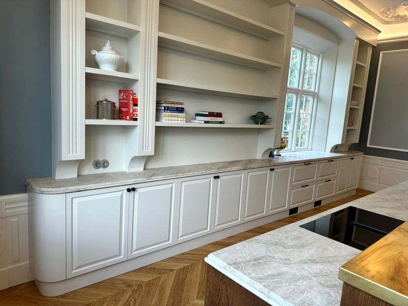 White kitchen with profiled doors and natural stone worktop