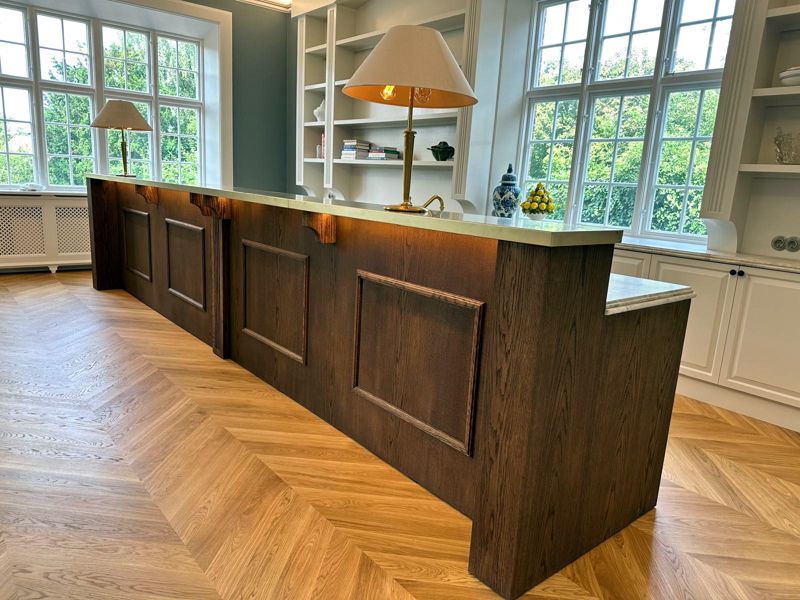 Oak kitchen island with panelled front and integrated lighting