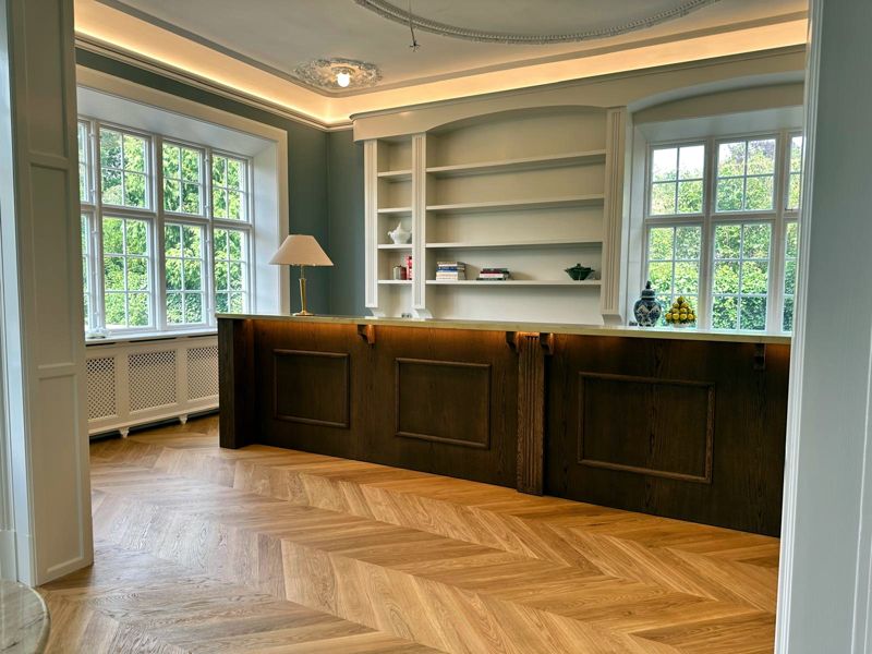 Kitchen island in smoked oak with panelled fronts and natural stone
