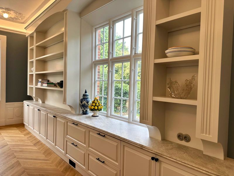 White shelving and kitchen units around a window