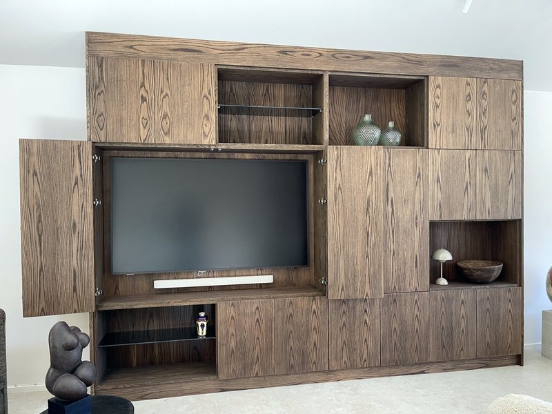 TV cabinet in smoked oak with folding doors that hide the screen