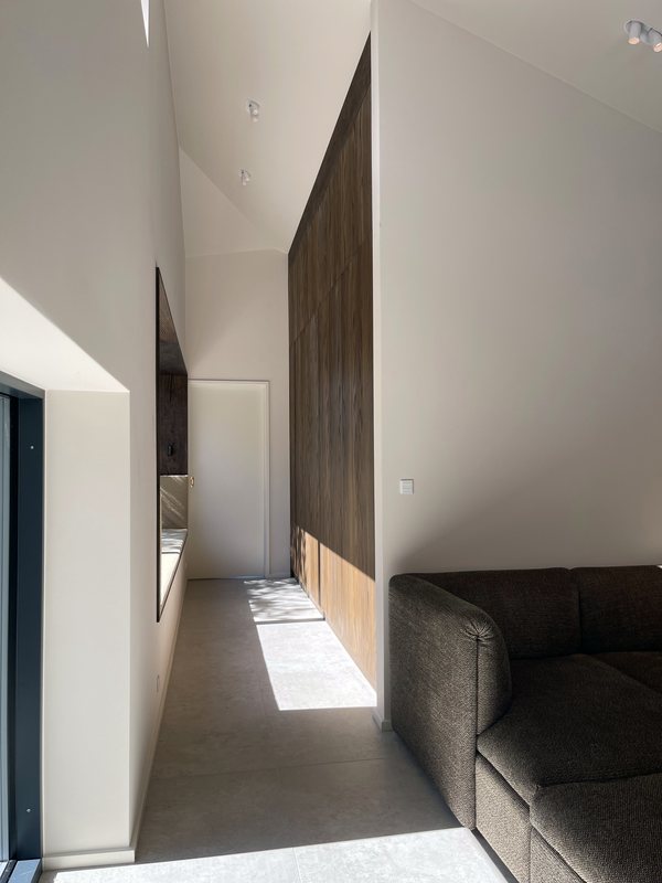 Smoked oak wall panelling in hallway with window niche