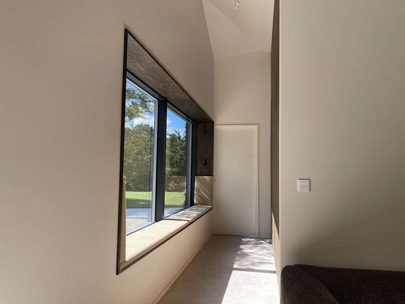 Window seat with cushion and view of the garden