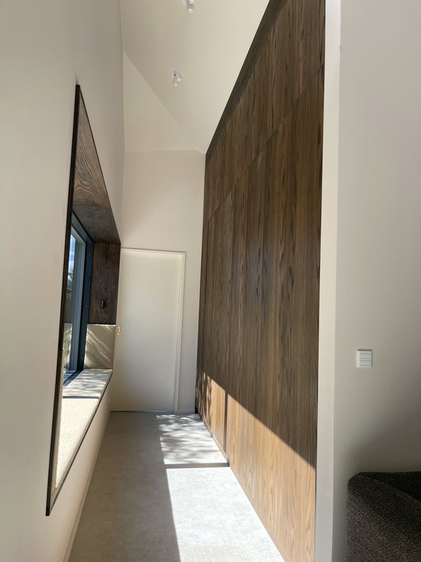 Window seat beside a smoked oak wall