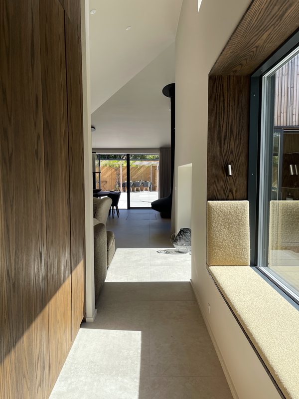Window seat with bouclé cushion and oak panelling