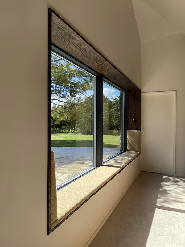 Window seat with cushion and smoked oak surround